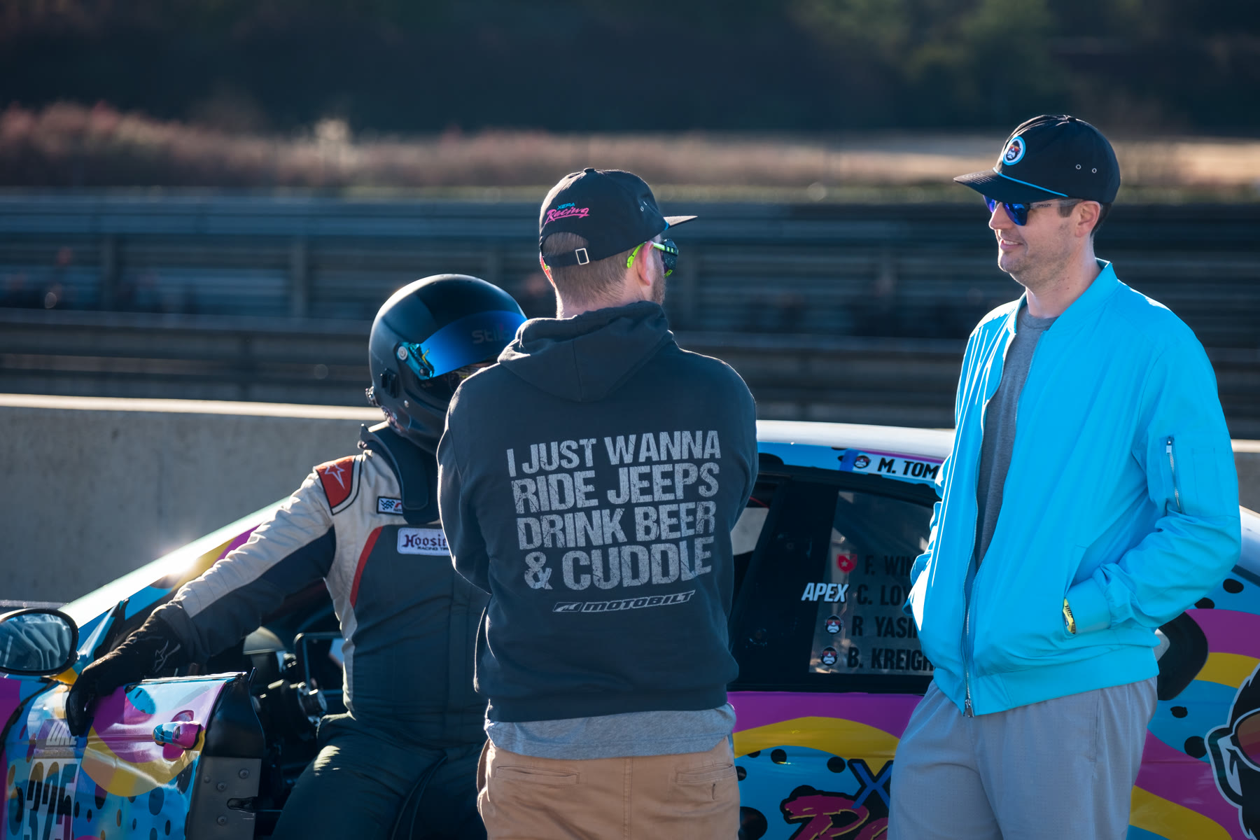 Cody talking with teammates beside the XEPA Racing car between sessions